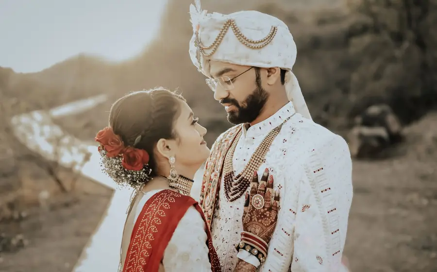 Bride and groom in wedding clothes posing outdoors