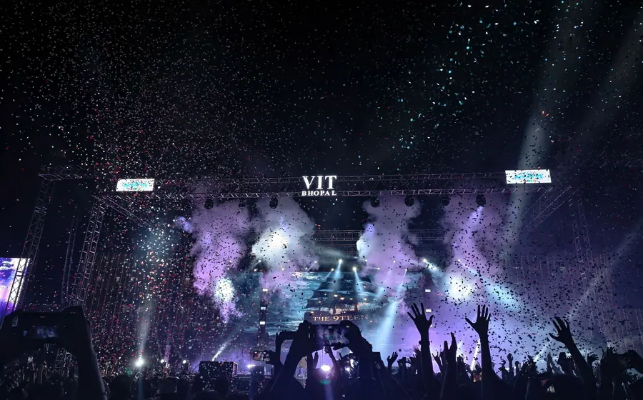 Confetti falling over a crowd at a night concert