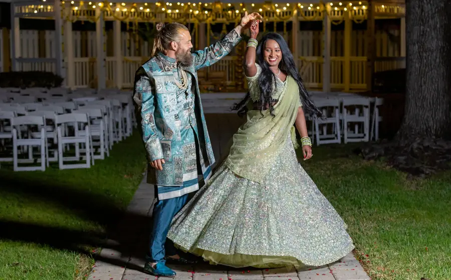 Couple dancing together on the lawn at their reception