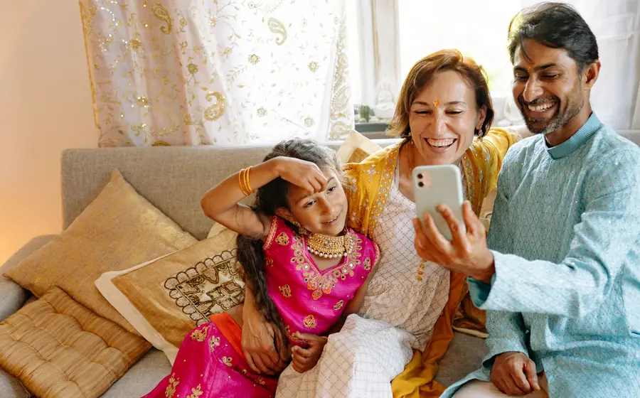 Family taking a selfie together on a sofa