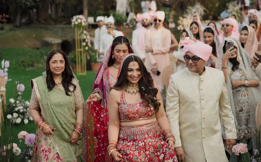 Bride walking with her family at an outdoor wedding